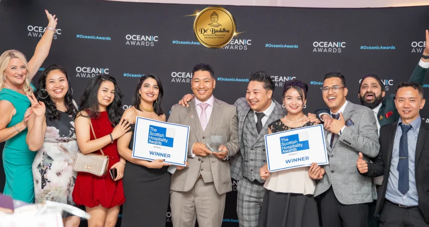 Dé Buddha team receiving the “Best Dining Experience” award on stage.